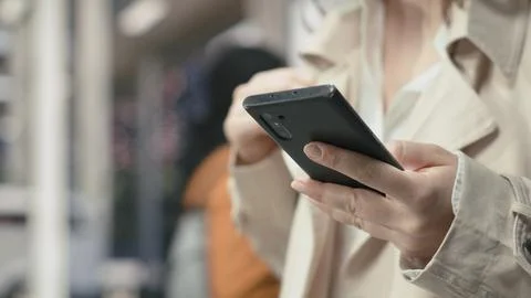Close up of traveler using smartphone device in bus station Stock Photos
