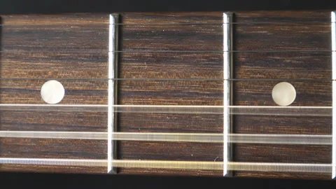 Close up of trembling guitar strings against fret. Chords being strummed and Stock Footage 329162921