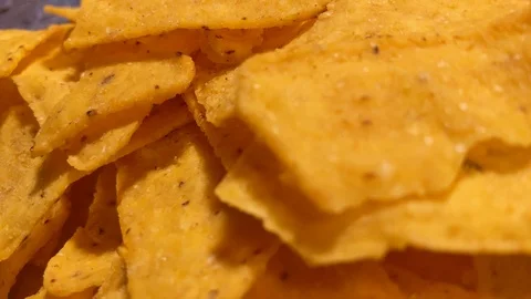 Close up. Triangle nachos corn chips slowly rotating. Unhealthy  스톡 동영상 120609765