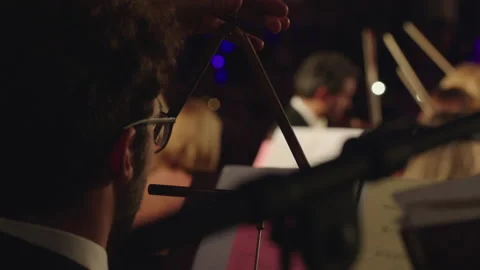 Close Up Of Triangle Player in Orchestra from Behind Stock Footage 206543894
