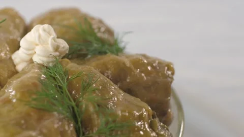 Close up of triangular stuffed cabbage, rotating in a glass bowl. Video stock 157797222