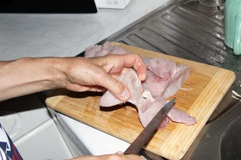 Close-Up of Trimming Small Piece of Raw Poultry Meat Stock Photos