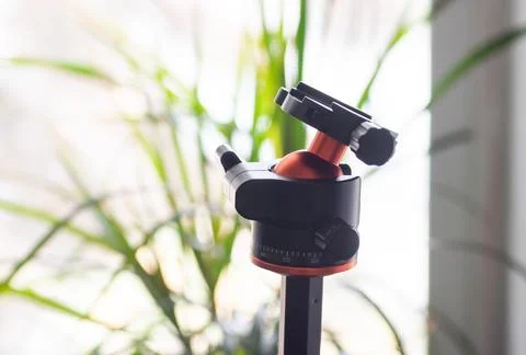 Close-up of a tripod head against a blurred background. Stock Photos