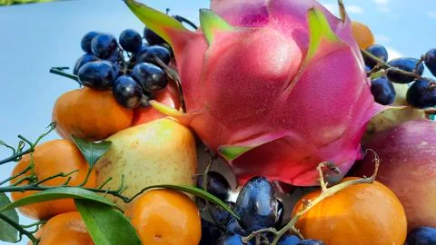 Close up, tropical fruit grapes, oranges, dragon fruit, pears and apples on a Stock Photos