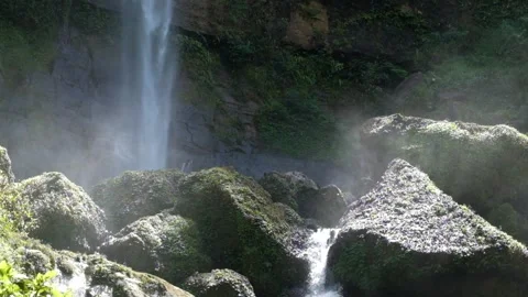 Close up of a tropical rainforest waterfall flowing rapidly crashing against Stock Footage 319878857