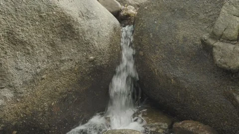 Close up tropical water stream between stones. loop. Stock Footage 332452134