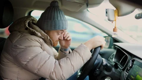 A close-up of a troubled driver with a headache Stock Footage 234137228