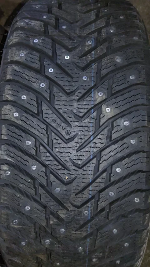 Close-up of a truck tire tread with embedded studs and deep grooves Stock Footage 346638410