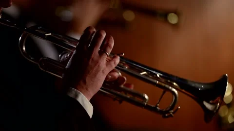 Close-up of a trumpeter of a classical orchestra playing in an orchestra pit for Vidéo 220193907