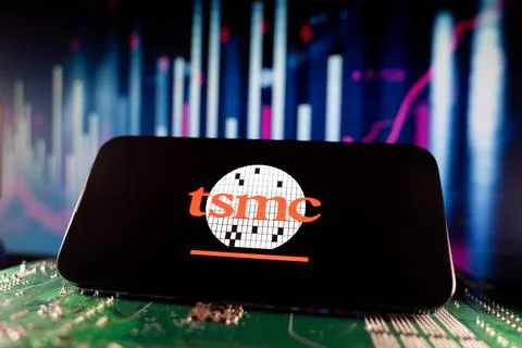 Close up of TSMC logo on smartphone screen with financial chart background. Foto stock