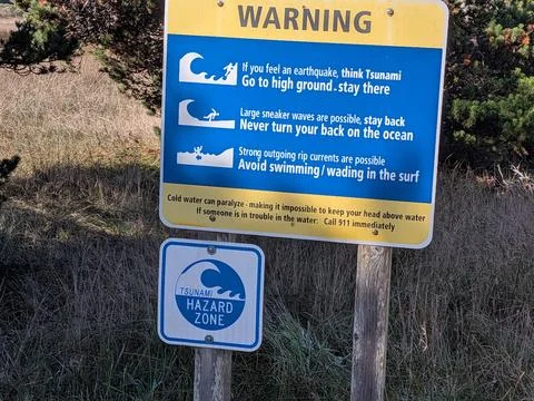 Close-up tsunami warning sign explaining earthquake evacuation steps Photos