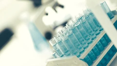 Close up. tubes of blue liquid in the science lab Stock Photos