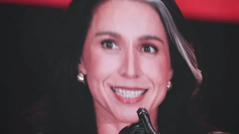 A close-up of Tulsi Gabbard on the video wall at the Charlie Kirk memorial Stock Footage 345298238