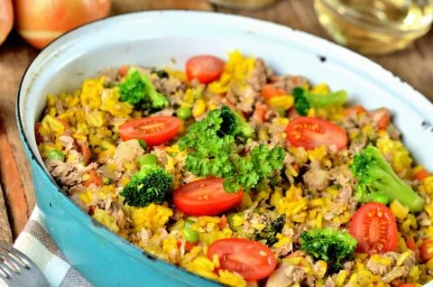 Close-up of tuna risotto with vegetables, tomatoes, broccoli and parsley in the Stock Photos