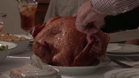 Close of turkey leg being twisted off a baked Thanksgiving turkey, 4K. Stock Footage 81599018