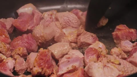 Close-up of turkey pieces boiling in a frying pan on low heat, healthy food home Stock Footage 309558250