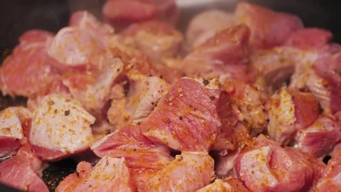 Close-up of turkey pieces boiling in a frying pan on low heat, healthy food home Stock Footage 314329028