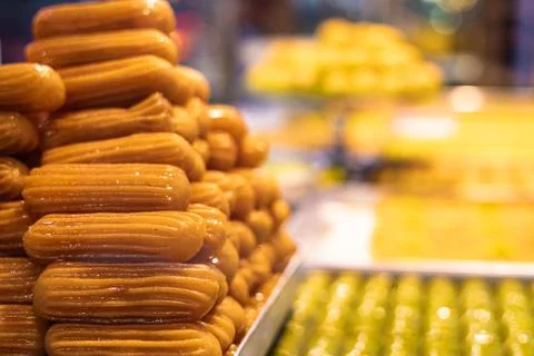 Close-up of a Turkish appetizing tulumba sweet in a display case. Copy space. Stock Photos