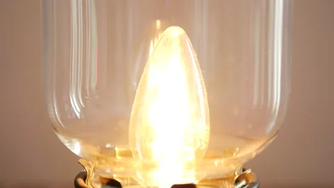 Close up turn on the light bulb old retro lamp. Vintage lamp design. Video stock 136880673
