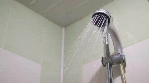 Close-up of turning on and off shower head in bathroom, falling drops in slow Stock Footage 265471115
