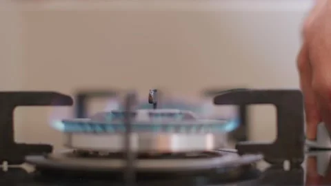 Close-up of turning on the burners on the strove. A fire is lit in three burners Видео 256614245
