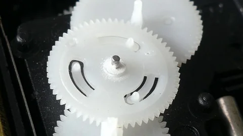 Close-up of turning cogs from inside a camera Stock Footage 81965578