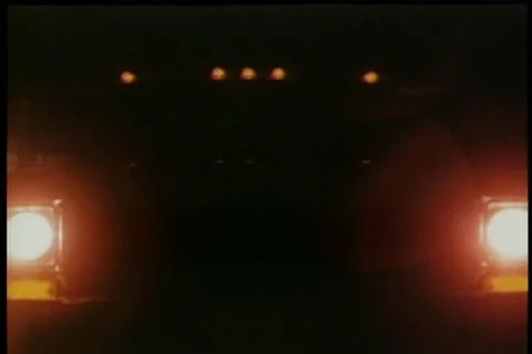 Close-up turning on headlights at night Stock Footage 11346440