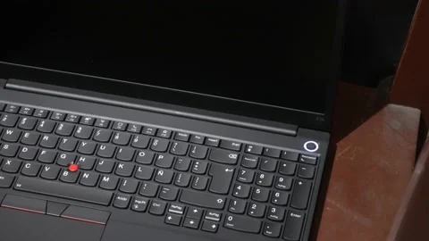 Close-up turning on by pressing the button of a recently purchased new Lenovo Stock Footage 157995269
