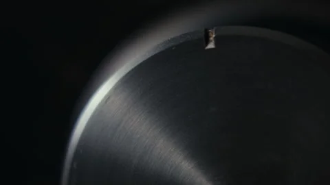 Close up of turning a shiny volume knob on audio amplifier Stock Footage