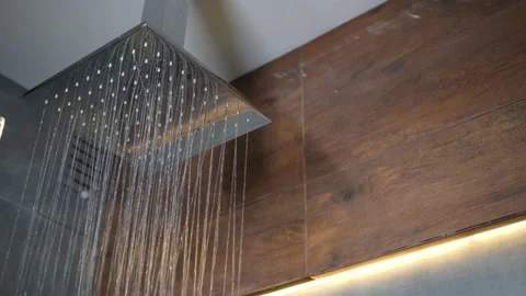 Close-up of turning on square shower head in bathroom with loft design, brown Stock Footage 238395637