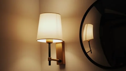 Close-up of a turning on the wall lamp. Earth Hour Concept. Stock Footage 310561912