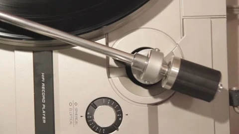 Close-up of a turntable head arm over spinning record Stock Footage 294947242
