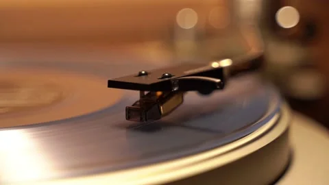 Close-up of a turntable head that rides on a blue vinyl plank Stock Footage 153964531