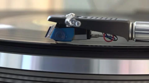 Close-up of the turntable needle engaging the vinyl record, with various arm Stock Footage 293089145
