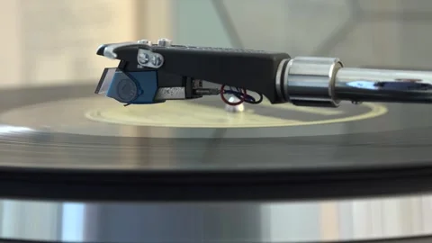 Close-up of the turntable needle engaging the vinyl record, with various arm Stock Footage 293089500