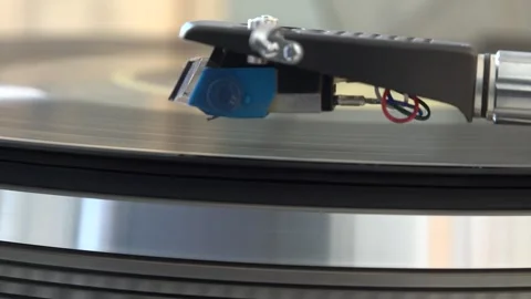Close-up of the turntable needle engaging the vinyl record, with various arm Stock Footage 293089832