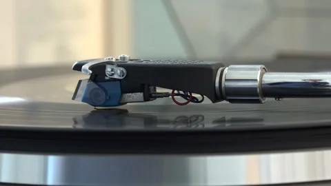 Close-up of the turntable needle engaging the vinyl record, with various arm Stock Footage 293090616