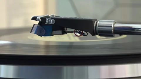 Close-up of the turntable needle engaging the vinyl record, with various arm Stock Footage 293090710