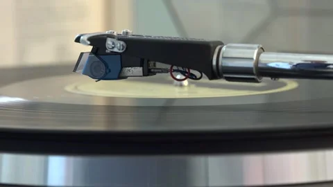 Close-up of the turntable needle engaging the vinyl record, with various arm Stock Footage 293090823