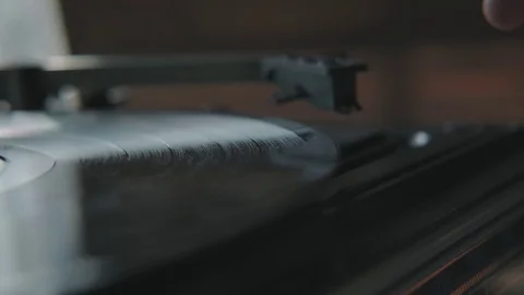Close-up: turntable needle on a vinyl record. Male hand puts a needle. Stock-Footage 116673404