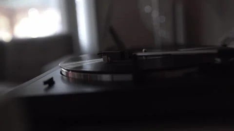 CLOSE UP OF TURNTABLE RECORD PLAYER IN DIM ROOM WITH SOFT WINDOW LIGHT Stock Footage 336961750
