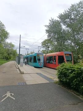 Close-up of turquoise and red trams meeting in Reims Stock Photos