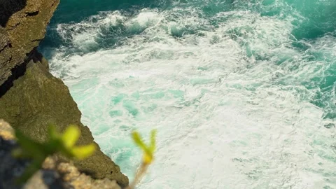 Close-up of turquoise ocean waves surging against coastal rocks Stock Footage 344140260