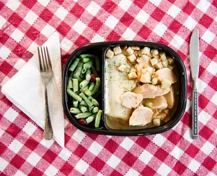 Close up of TV dinner on checked table cloth Stock Photos
