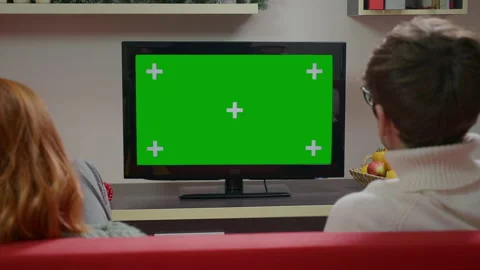 Close up TV Green screen Chroma Key. Lovely couple waching tv. Stock Footage 165011149