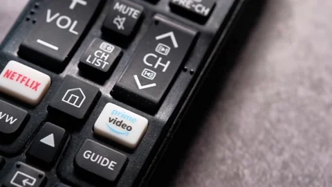 Close up of tv remote on table with netflix and amazon prime button Stock Footage 141125750