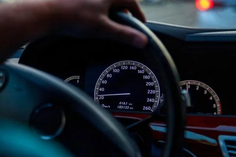 Close up of Twilight Drive With Focus on Speedometer and Steering Wheel Stock Photos