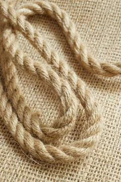 Close-up of twine on burlap representing sustainable packaging material Stock Photos