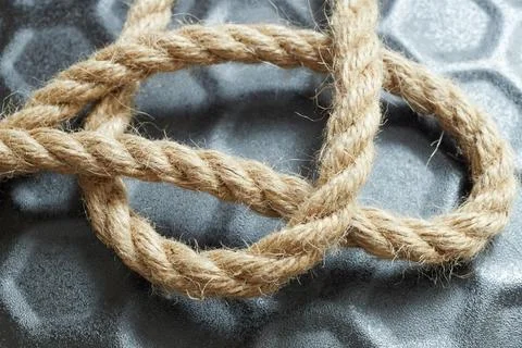 Close-up of a twisted twine string on black background for packaging industry Stock Photos