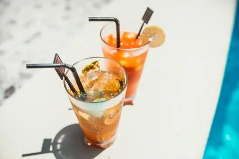 Close-up of two alcoholic drinks, mojito with lime and ice and gin and tonic  Stock Photos